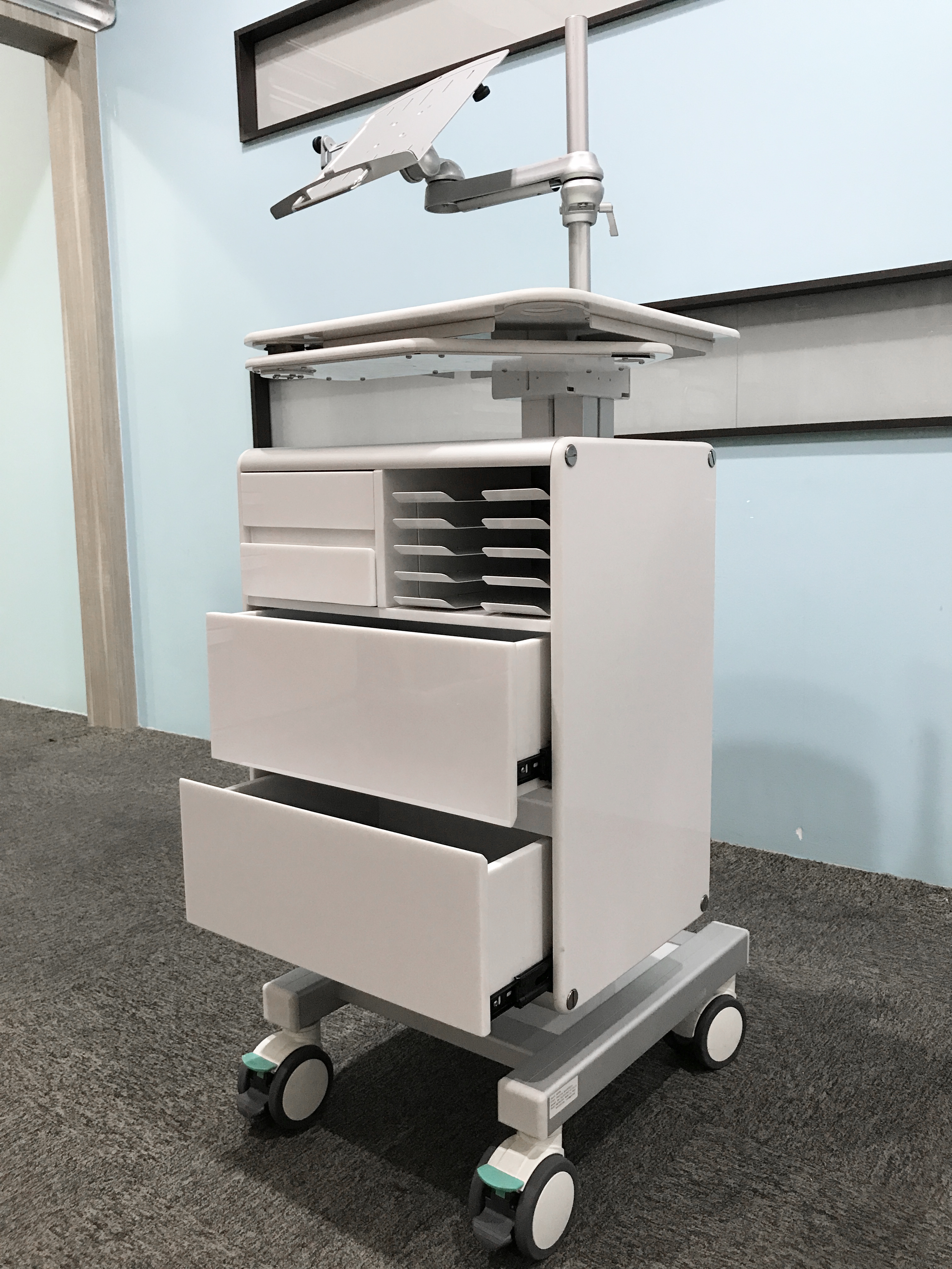 A mobile workstation which caters to convenient filing and storage of administrative related documents peripherals like patient reports and the like