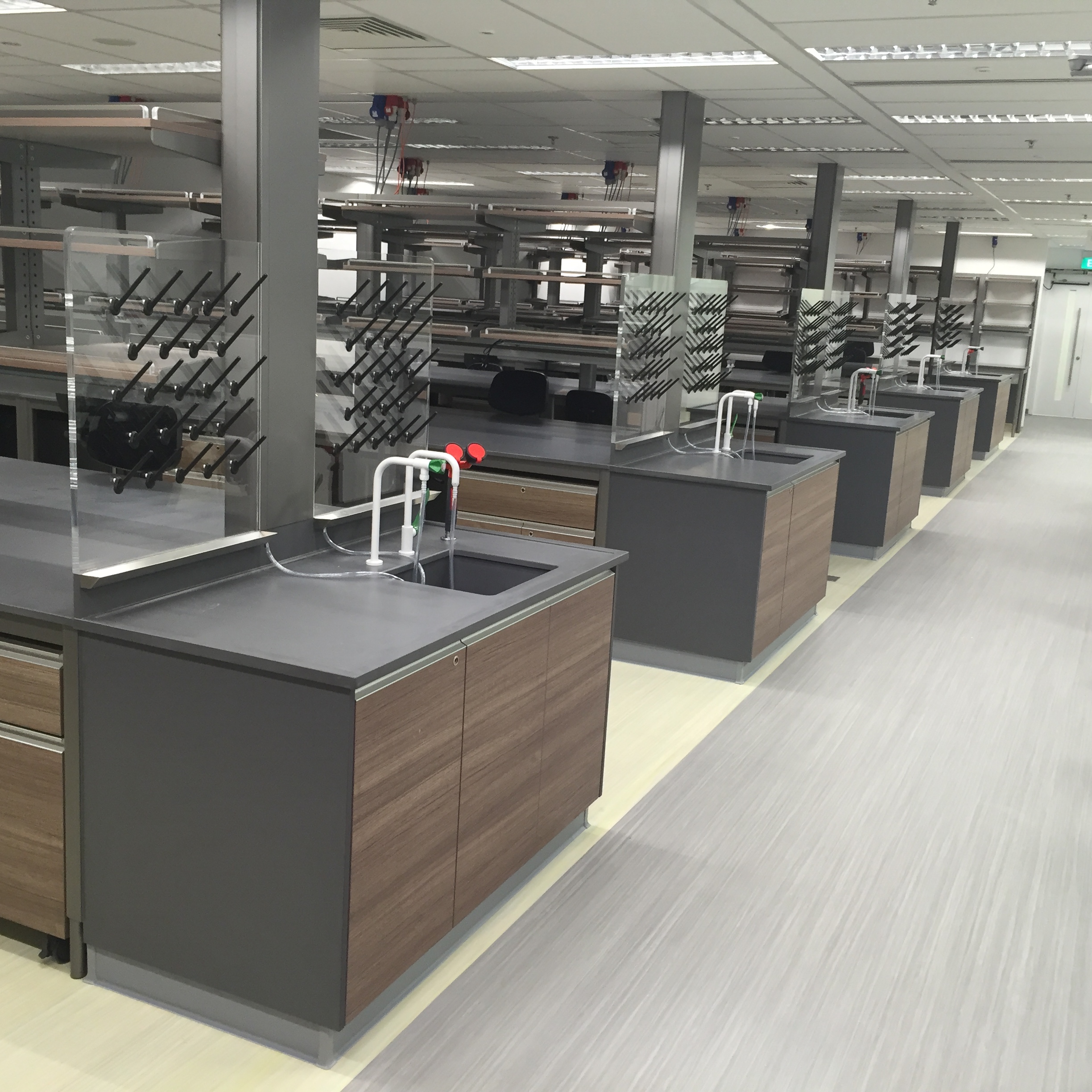 A premium high end laboratory hallway which shows Systmz lab bench tables and cabinets made with phenolic and chemical resistand epoxy worktops